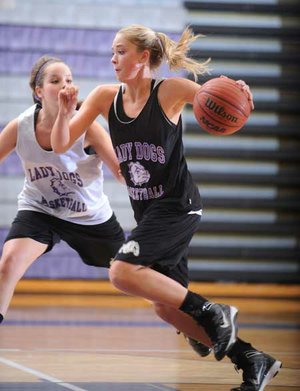 Fayetteville junior point guard Calli Berna, right, drives past junior guard Clair Childers during practice Thursday in Fayetteville.