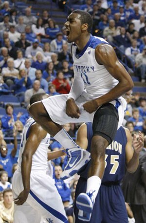 Kentucky’s John Wall lets out a yell after dunking during the first half of an exhibition game against Clarion on Friday night in Lexington, Ky. Wall is part of a recruiting class that has been ranked No. 1 nationally and is expected to help lead the Wildcats back to prominence.