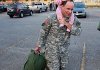 Gracie Massey, 2, rides atop her father's shoulders as Spec. Joseph Massey loads his duffle onto a bus as he and other soldiers from Arkansas National Guard's 875th Engineer Battalion prepare to leave Jonesboro Tuesday morning. 