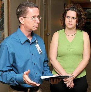  STAFF PHOTO DAVID FRANK DEMPSEY 
Jim Wheeless, Geographic Information System data manager for Bentonville, with his wife, Jennifer Wheeless, talks Tuesday about his work on the city’s Web site. Wheeless was credited by Bentonville Mayor Bob McCaslin with having built the city’s system.