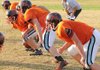Gravette coach Bill Harrelson, background, watches as his offensive linemen works on a drill during Tuesday’s practice. The Lions host Valley View in the first round of the Class 4A playoffs on Friday.