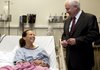 This image provided by the U.S. Department of Defense shows Secretary of Defense Robert M. Gates meeting with Police Sgt. Kimberly Munley at a hospital in Fort Hood, Texas, on Tuesday Nov. 10, 2009. Munley was a first responder who fired shots at the suspected shooter during the recent tragedy at the Army processing station. 