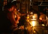 People eat by candlelight at a restaurant at the Copacabana beach in Rio de Janeiro during a blackout Tuesday.