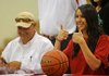 Hanna Qedan of Farmington gives the thumbs-up sign after signing a basketball letter of intent Wednesday to play for Arkansas State. Qedan’s father, Bashar Qedan, is pictured at the left.
