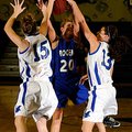 Rogers High sophomore guard Sarah Grace Groves, left, and junior guard Madeline Fusillo block the sh...