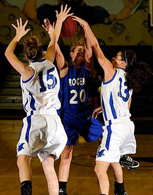 Rogers High sophomore guard Sarah Grace Groves, left, and junior guard Madeline Fusillo block the shot of sophomore Lydia Wilkerson during the first half of their Blue-White scrimmage Wednesday.
