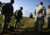 Snipers from various service branches wait to be taken up in a Chinook CH-47 helicopter for the air born shooting competition during the Inter-Service Sniper Sustainment Training Exercise Wednesday.