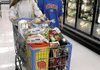 Laura Godfrey (left) and Elizabeth Godfrey shop for groceries this week at a Wal-Mart store in Rogers. The grocery segment saw almost half of Wal-Mart’s sales in the past fiscal year.
