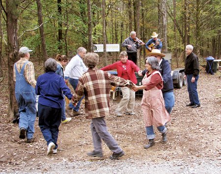 the-toe-tapping-fiddle-music-of-bill-thurman-and-tim-trawick-caused-a-group-of-people-to-form-a-square-dance-set-complete-with-a-caller-at-trail-day-at-the-south-fork-nature-center-in-choctaw