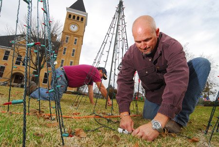 johnny-dawson-left-and-dj-whorton-do-final-detail-work-on-some-of-the-lights-decorating-the-lawn-of-the-saline-county-courthouse