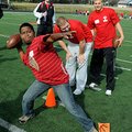 Jerwin Billy, 13, throws a football Thursday as Heritage High School football players Sam Clark, cen...