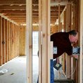 Rick Bramall, chief plans examiner for Springdale, inspects a new home Thursday on Rosemary Avenue i...