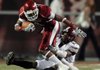 Arkansas' Jarius Wright is tackled by Troy's Bryan Willis during the first quarter of the Razorbacks game Saturday night in Fayetteville.
