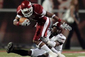 Arkansas' Jarius Wright is tackled by Troy's Bryan Willis during the first quarter of the Razorbacks game Saturday night in Fayetteville.