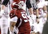 Arkansas defensive tackle Lavunce Askew celebrates after he and Tenarius Wright sacked Troy quarterback Levi Brown in the fourth quarter Saturday night in Fayetteville. It was the only time the Arkansas defense was able to sack Brown.