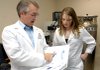 Kimberly Reynolds, a University of Arkansas for Medical Sciences graduate student in biochemistry and microbiology, and Kevin Raney, professor of biochemistry, talk about the results of a mass spectrometer Friday at the Arkansas Biosciences Institute.