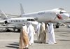 United Arab Emirates officials and visitors pass an Airbus plane on Sunday at the Dubai Airshow.