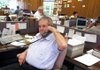 Lawrence Schmieding works a phone selling produce in at Schmieding Produce in 2005. He died Monday at the Circle of Life Hospice in Springdale.