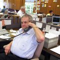 Lawrence Schmieding works a phone selling produce in at Schmieding Produce in 2005. He died Monday a...