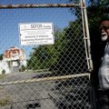 Dwight Salisbury, manager of the Southwest Radiation Calibration Center, unlocks the gate leading to...