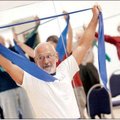 Jack Moody of Rogers leads an exercise class group Tuesday inside the Adult Wellness Center in Roger...