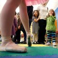 Kim Borsodi, 4, and Ella Dux, 2, both of Fayetteville, take a cautious look at the Sugar Plum Fairy ...