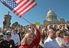 Pam Hooper, center, from Little Rock, joins hundreds of others at the State Capitol Building on Thursday for an anti-healthcare overhaul rally organized by members of Americans for Prosperity.