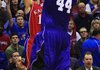 Kansas guard Tyrel Reed (left) takes a three-point shot over Central Arkansas’ Carlos Dos Santos in the first half of the Jayhawks’ 94-44 victory Thursday night. Reed had 12 points, all on three-point shots. 