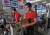Lee Deaton, left, and Nathan Schmidt box up a wine order Thursday for a customer at Crossover Liquor in Fayetteville.