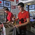 Lee Deaton, left, and Nathan Schmidt box up a wine order Thursday for a customer at Crossover Liquor...