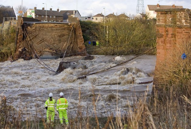engineers-survey-the-scene-after-a-bridge-over-the-river-derwent-collapsed-suddenly-after-heavy-rainfall-and-flooding-in-workington-england