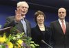 The new European Union president, Herman Van Rompuy, (left), stands Thursday with the EU’s new foreign policy chief, Catherine Ashton, and Swedish Prime Minister Fredrik Reinfeldt in Brussels. 