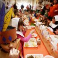 Dressed as an American Indian, Angielit Cabrera, 6, licks her fingers while enjoying a Thanksgiving ...