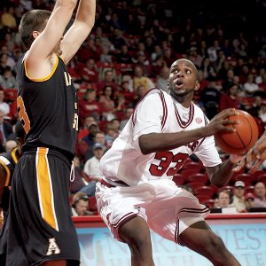 Arkansas’ Marshawn Powell looks toward the basket over the outstretched arms of Appalachian State’s Tyler Webb. Powell led all scorers with 29 points in an 81-72 overtime victory.