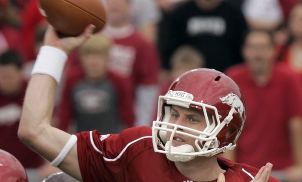 arkansas-quarterback-ryan-mallett-passes-under-pressure-from-mississippi-state-defensive-tackle-sean-ferguson