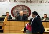 Jervonne Newsome passes by Lilia Pacheco (seated), her partner on the Arkansas State University team, to give her oral arguments in the semi-finals of the National Undergraduate Moot Court Championships at the UALR Bowen School of Law in Little Rock Saturday. The judges are (left to right) Bill Waddel, Rob Shafer (both attorneys) and Tim Fox, an Arkansas Circuit Court Judge.