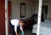 Housekeeper Twyla Davis cleans up broken glass Friday from Room 139 in the National Park Inn in Hot Springs, where a man was killed Thursday in a police shootout.