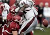 Arkansas defenders tackle and knock the ball from Mississippi State’s Anthony Dixon in the third quarter of the Razorbacks 42-21 victory Saturday at War Memorial Stadium in Little Rock. The Razorbacks followed that with a drive that resulted in an 11-yard touchdown pass to Greg Childs.
