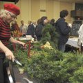Juli Odum with Urban Jungle of Farmington, finishes a fresh wreath Saturday as shoppers browse the B...