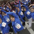 Young runners stretch Saturday before running in the New Balance Girls on the Run of Northwest Arkan...