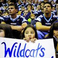 Yesenia Facundo, middle, holds a Wildcats sign as she sits with classmates Halle Roberts, right, and...