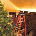 ake McClintock of Lubbock, Texas, adjusts the limbs of the Chrismon Tree on Sunday at First United P...