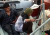 Survivors from a sunken ferry are seen on a rescue ship upon arrival at Tanjung Balai Karimun port in Indonesia on Sunday.