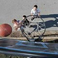 CJ Wilson, 13, of Springdale, left, takes a shot as Logan Aaserude, 13, of Hindsville reaches to def...