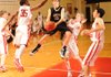 Bentonville Black’s Collin Roberts, center, takes a shot over Fayetteville Ramay’s Quinn Simkins, right, as guard Brice Gahagans, left, reaches to defend during the second half of Monday’s game in Fayetteville.