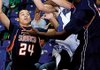Rogers High’s Wyatt Hively goes up for the shot as Subiaco Academy Keon Walters, right, and Mickell Salley block during the first half of Monday’s game in Rogers.