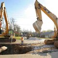 Workers with Seven Valleys Construction of Cassville, Mo., work Monday to remove a damaged pipe that...