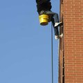 Bob Shackelford reaches to replace a holiday bulb Monday on the Washington County Courthouse while u...