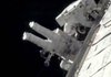 Astronaut Randolph Bresnik and Dr. Robert Satcher Jr. work on the International Space Station during a spacewalk Monday in this image from video released by NASA.