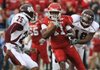 Arkansas receiver Cobi Hamilton spins away from Mississippi State defenders Corey Broomfield (25) and Marcus Washington (18) to his second touchdown in Saturday’s 42-21 victory.